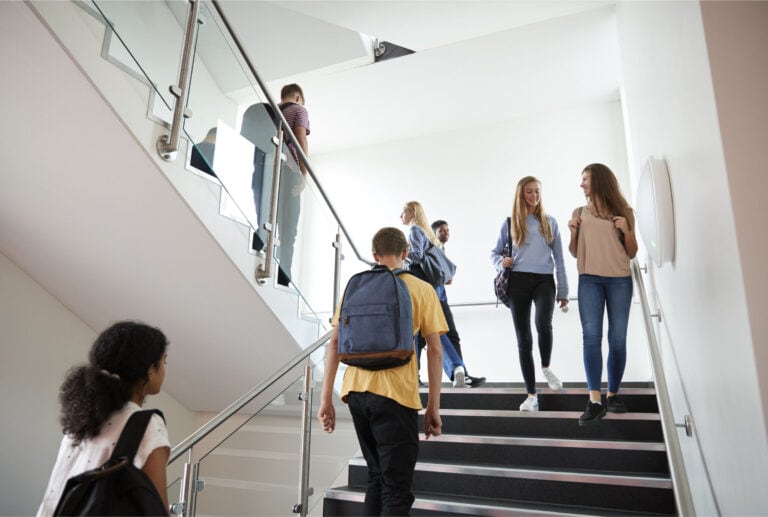 This images show students walking on a staircase in a high school.