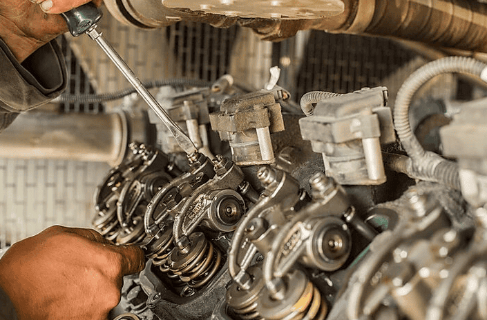 Mesa Power Solutions technician working on an engine inside a generator.