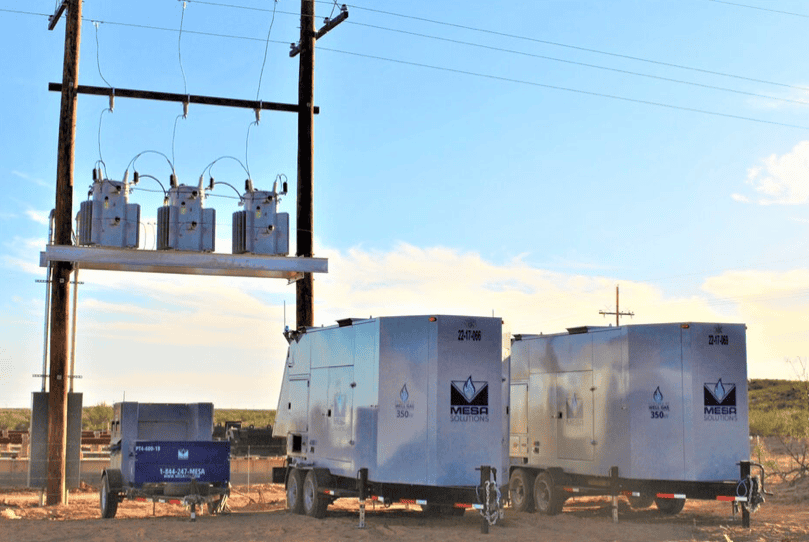 Mesa Power Solutions 350kw generators and panel trailer near a powerline.