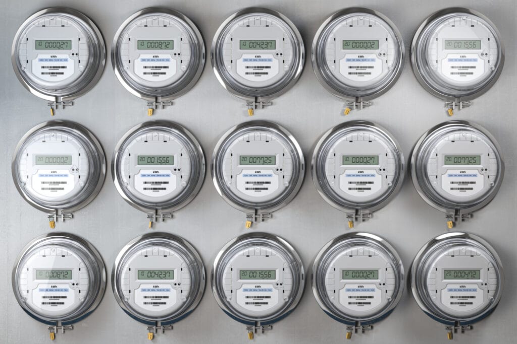 Digital electrical meters lined up in rows and columns, measuring power use.