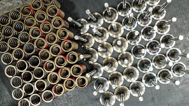 An aerial view of engine valves and coils in a Mesa Power Solutions machine shop.