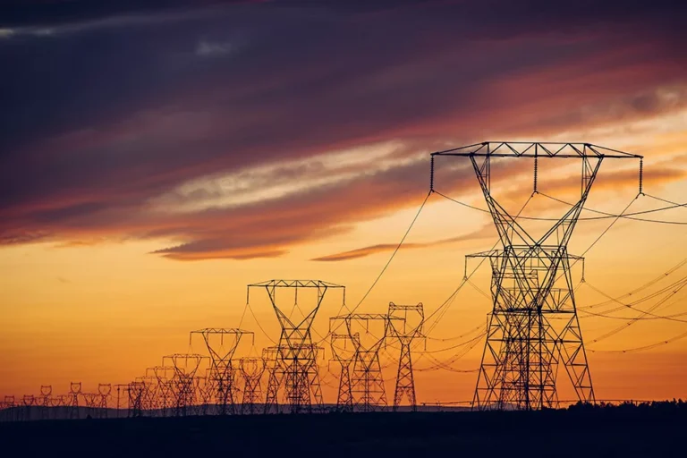 This image shows many power lines to represent the US electric grid at sunset, an image used by Mesa Power Solutions.