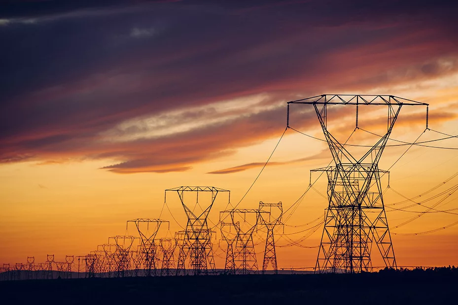 This image shows many power lines to represent the US electric grid at sunset, an image used by Mesa Power Solutions.