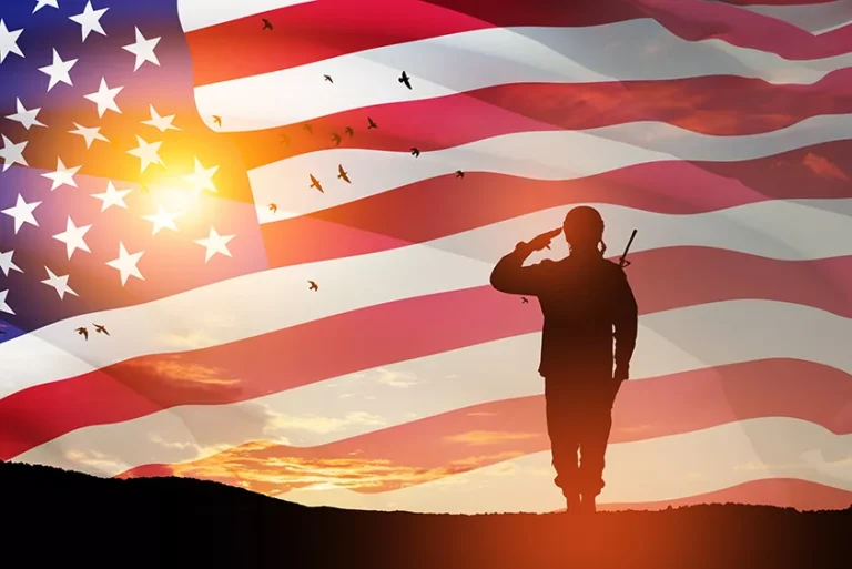 HIRE Vets Platinum Medallion, U.S. Army solider saluting at sunset with an American flag overlay in the background.
