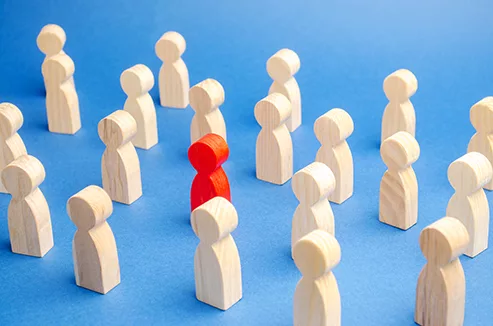 Little wooden people figures to signify a part of how a leader works with his team for Rules of Leadership.