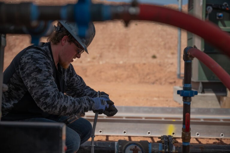 Mesa Power Solutions field technician performing line maintenance on generator infrastructure, demonstrating precision, safety, and expertise in reliable industrial energy operations.