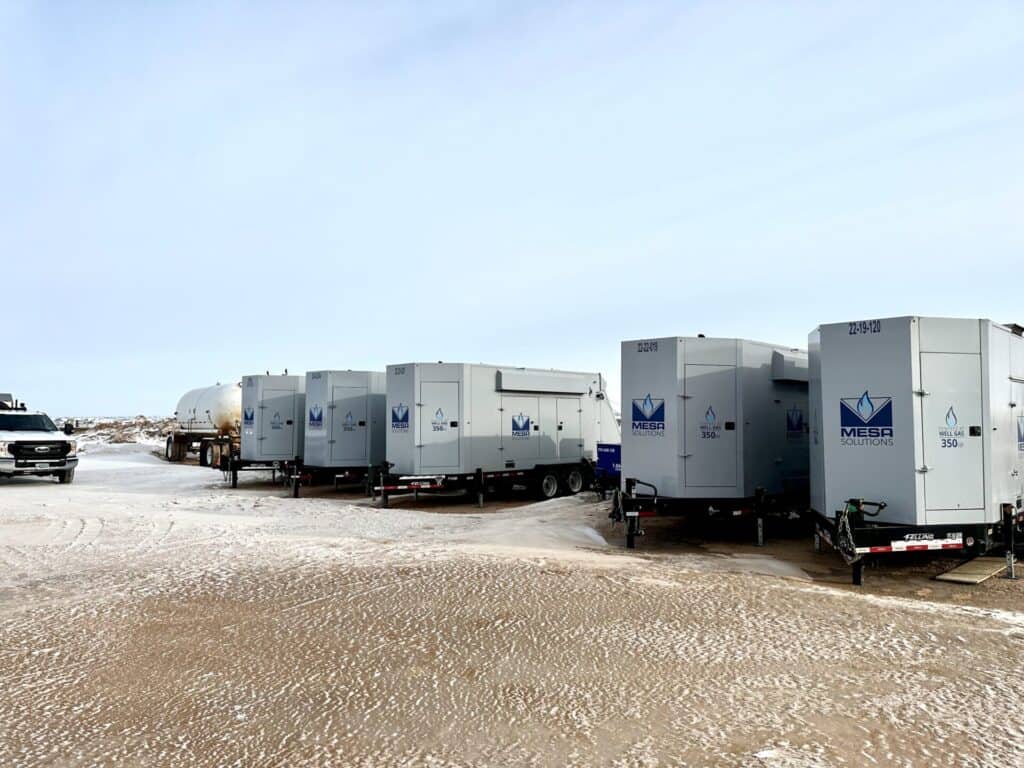 An image of 350kW natural gas generators lined up on a site with a Mesa tech truck.