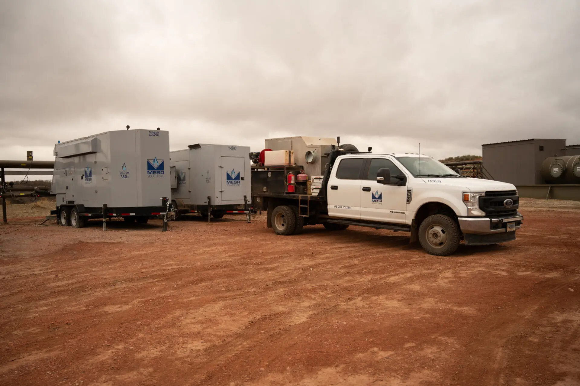 Generator technician on site with Mesa natural gas generators running.
