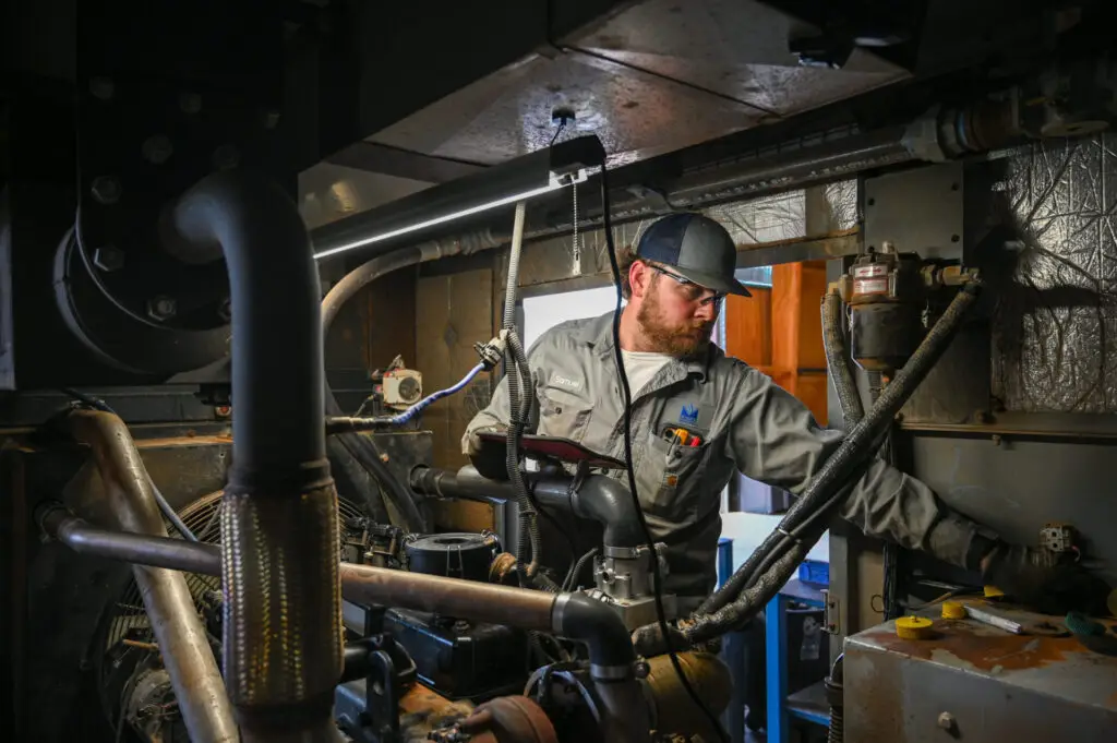 A service tech fixing a generator.