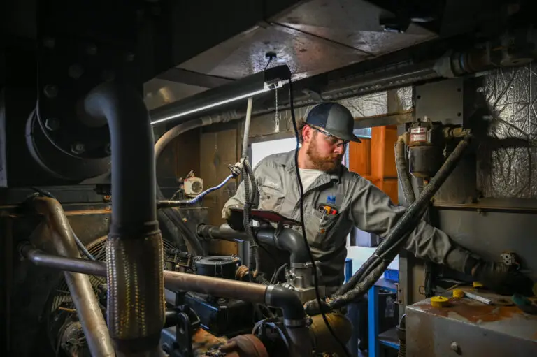A service tech fixing a generator.