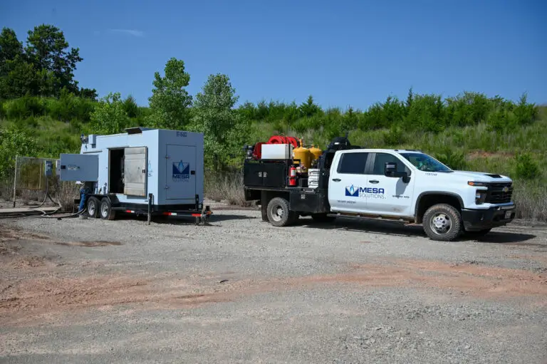A truck with a panel trailer that is currently being fixed by a technician.